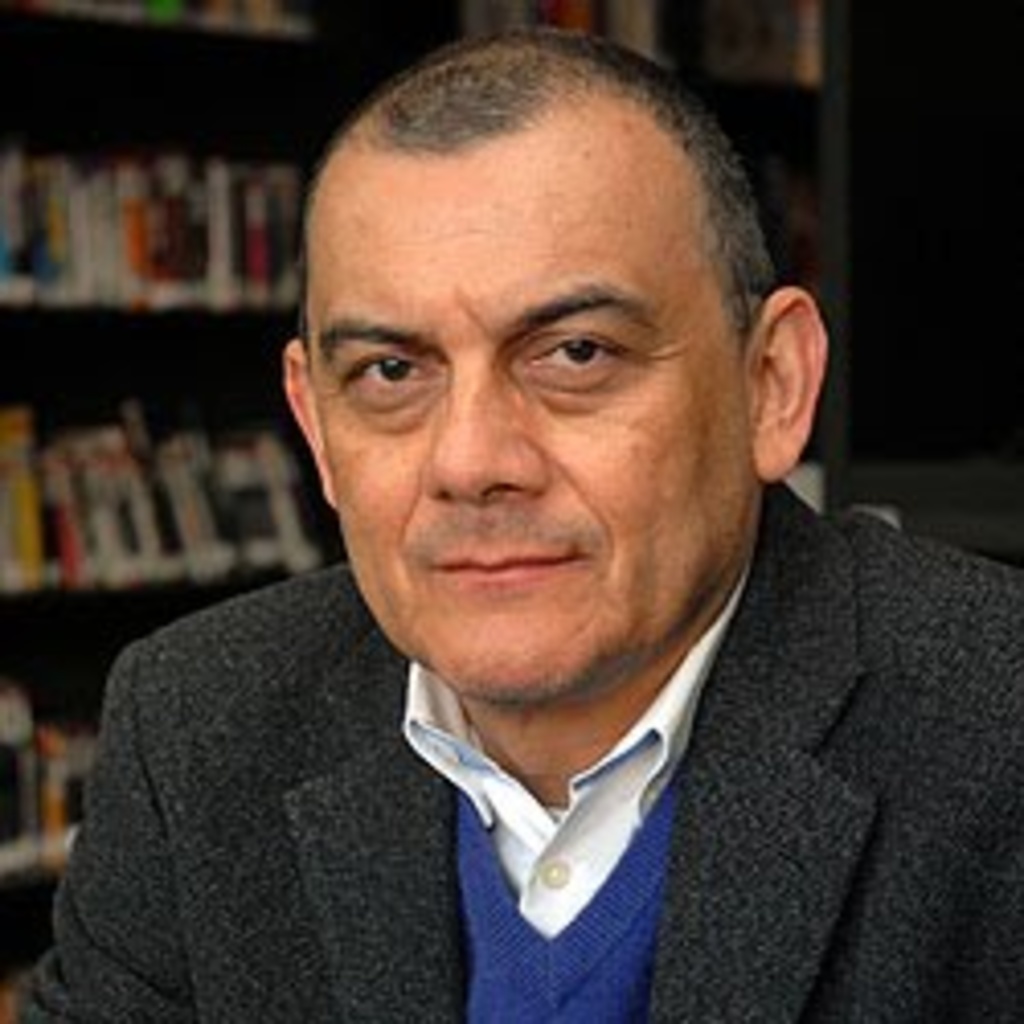 photo of H. Castellanos with bookcase background